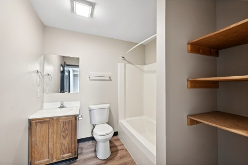 a bathroom with a toilet and a shower and a sink