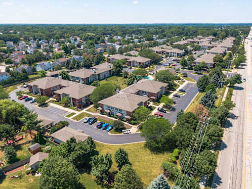 A suburban neighborhood with houses and a parking lot.
