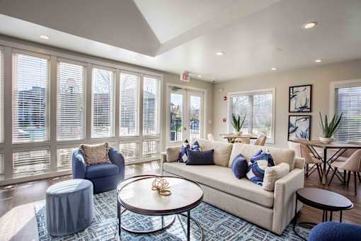 A living room with a couch, chairs, and a coffee table.