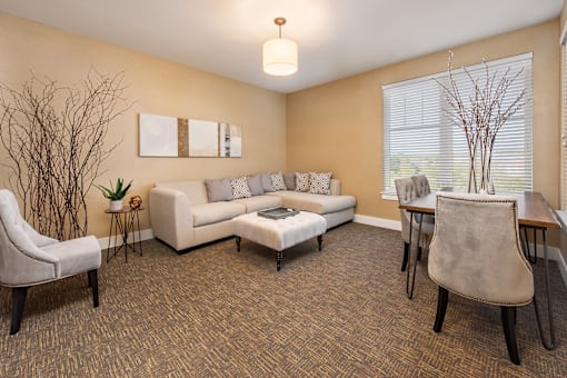A living room with a couch, chair, and table.