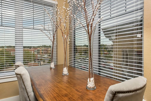 A dining room with a wooden table and chairs.