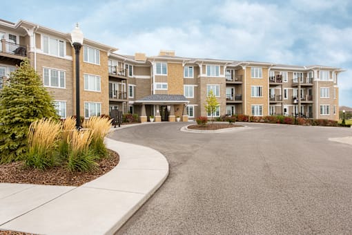 A large apartment complex with a circular driveway in front.