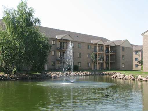 A building with a fountain in front of it.
