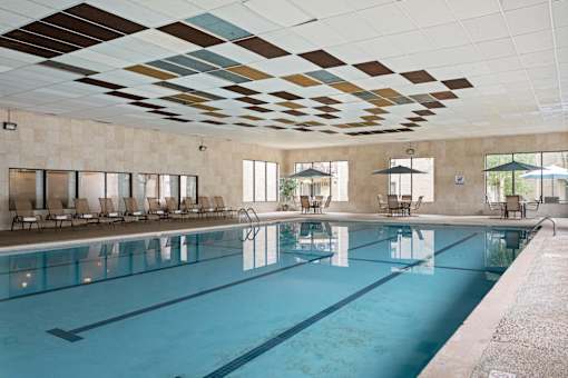 A large indoor swimming pool with a mosaic ceiling.