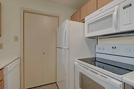A white refrigerator and microwave in a kitchen.