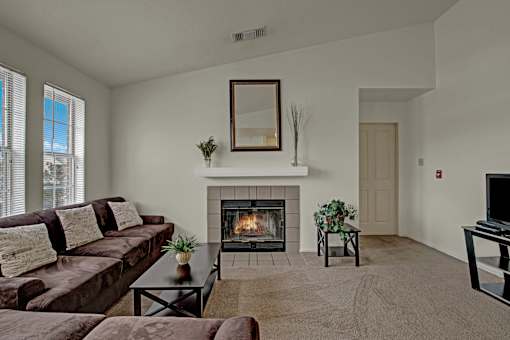 A living room with a fireplace and a couch.