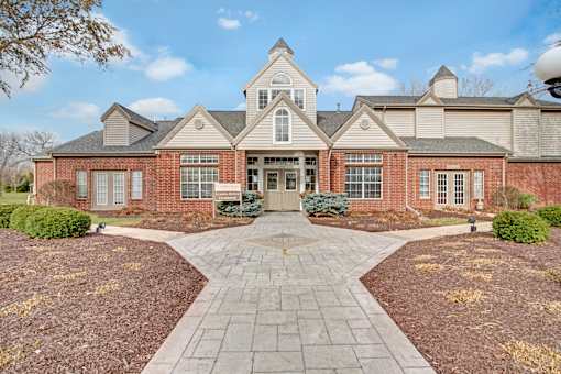 A large brick building with a central entrance and a symmetrical design.