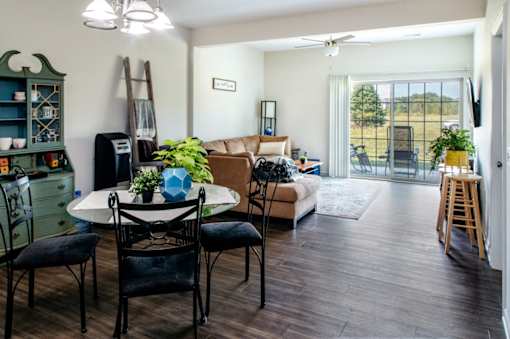 A living room with a white table and chairs.