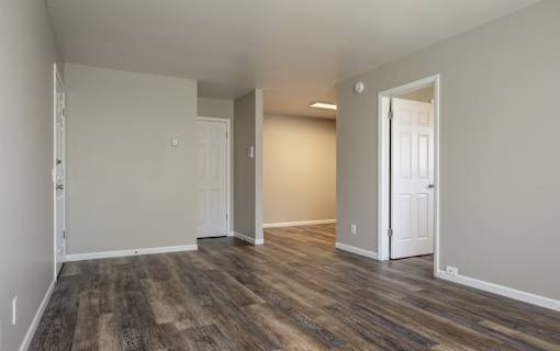 A room with wooden floors and white walls.