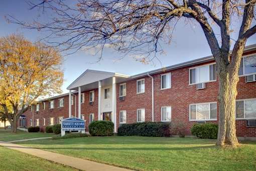 A brick apartment building with a sign in front that says "Bethesda".