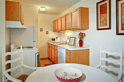 A white table with a plate on it in a kitchen.