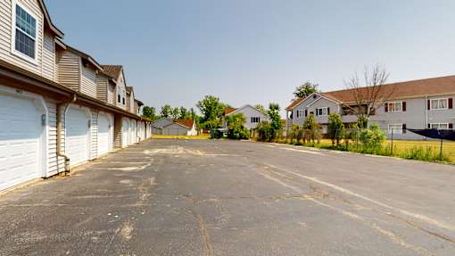 A parking lot in front of a row of houses.