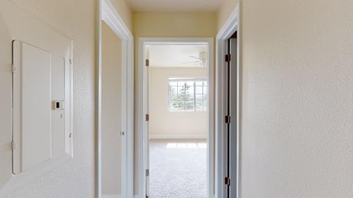 A white door is open to a hallway.
