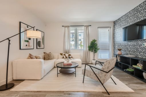 a living room with a white couch and a black coffee table