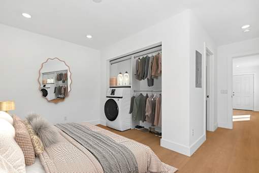 Spacious bedroom in Mar Vista apartment with large closet, washer/dryer, plank flooring and private bathroom