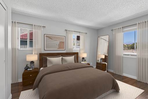 Spacious bedroom in 1 bed 1 bath Azusa Gardens apartment home with wood style plank flooring, multiple windows for natural lighting and views, and a private bathroom