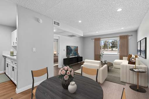 View of spacious living area from dining nook in Azusa Gardens 1 bed 1 bath apartment home with wood-style plank flooring and view of large window allowing for gorgeous natural light to filter throughout the space