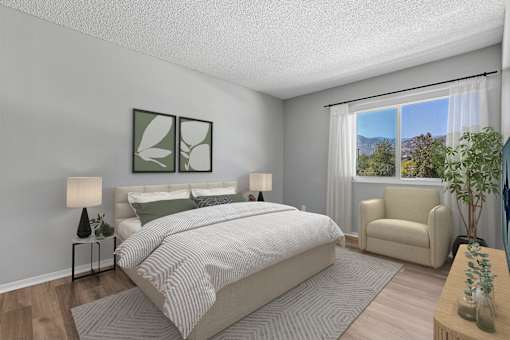 Spacious primary bedroom in Azusa Gardens 2 Bed 1 Bath apartment home with wood-style plank flooring, large windows, and a oversized closet.