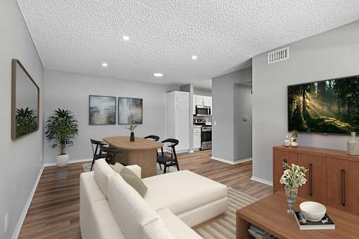 Living area in 2 bed 1 bath Azusa Gardens apartment home which leads into the dining nook and kitchen. Wood-style plank flooring, large windows and open concept layout makes the space feel spacious inviting and serene.