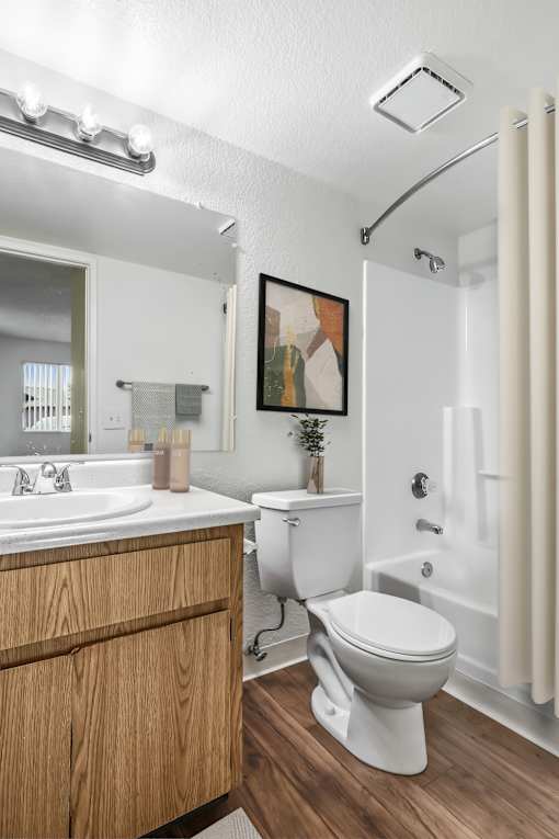 Second Bathroom in Bent Tree 2 Bed 2 Bath apartment home with wood plank-style flooring, light cabinetry, a large vanity mirror and a shower/tub