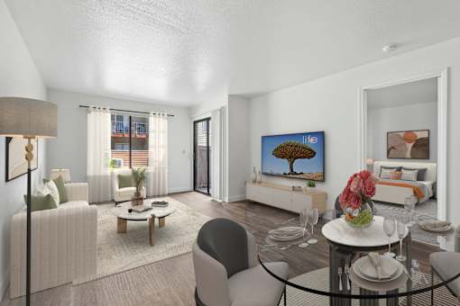 A living room with a couch, chairs, a coffee table, and a painting on the wall.