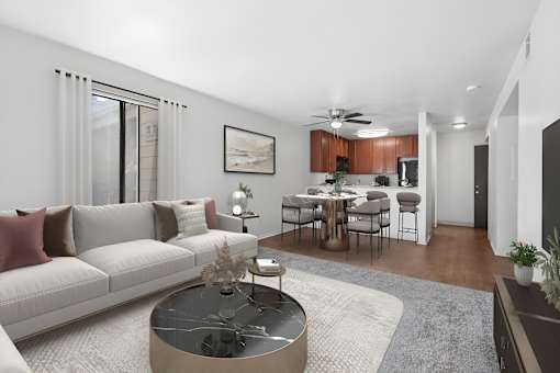 Spacious living area in 2 Bedroom California place apartment home with plush carpeted flooring and large sliding doors leading to private patio/balcony. Open concept floor plan layout leads to the dining nook with wood-style plank flooring and a ceiling fan