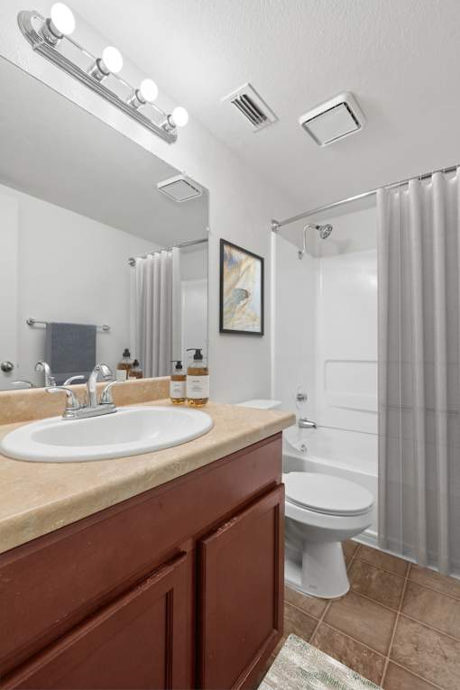Bathroom 1 in 2 Bedroom California Place apartment home with a shower/tub, large vanity mirror, and plenty of cabinet space