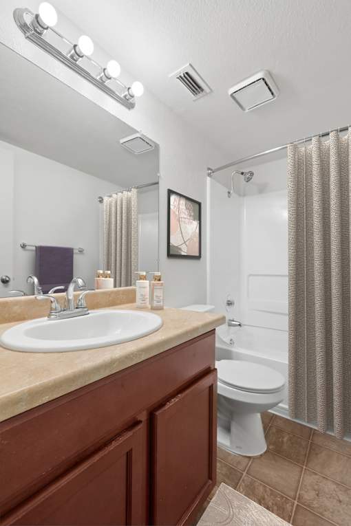 Bathroom 2 in 2 Bedroom California Place apartment home with a shower/tub, large vanity mirror, and plenty of cabinet space