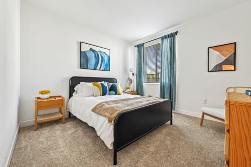 a bedroom with a bed and a dresser and a window