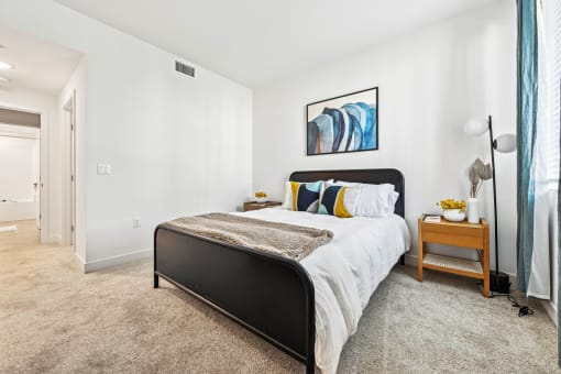 a bedroom with a bed and a large window