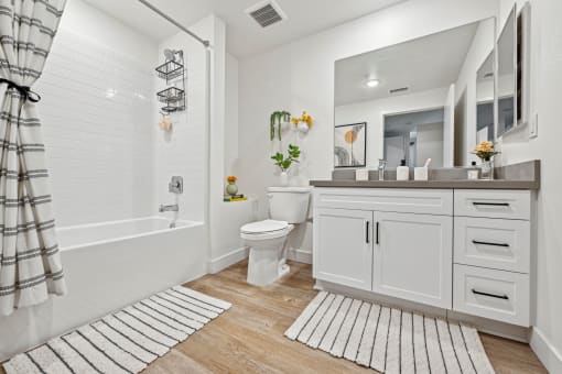 a white bathroom with a shower and a toilet