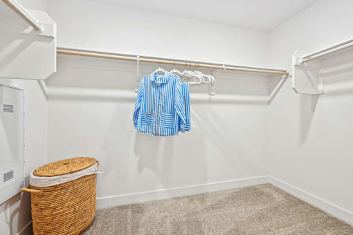 our spacious walk in closet is loaded with clothes and towels and has a large closet