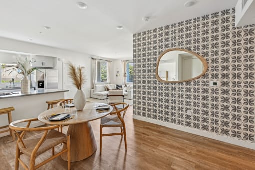 a dining room with a table and chairs and a mirror