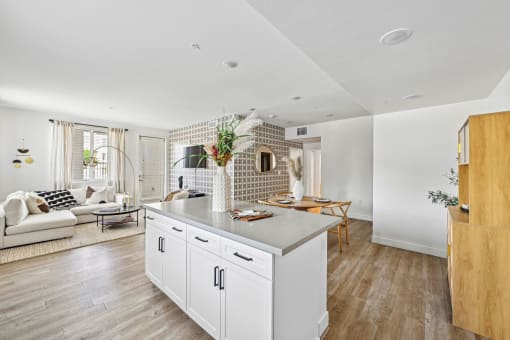 a kitchen with a large island and a living room