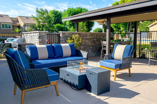 blue couches and chairs and a fire pit