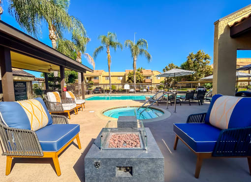 the pool area at our apartments fire pit with chairs
