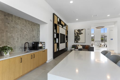 a kitchen and living room with a white counter top