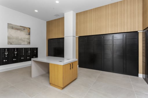 a wine room with black lockers and a counter and a wall of cabinets
