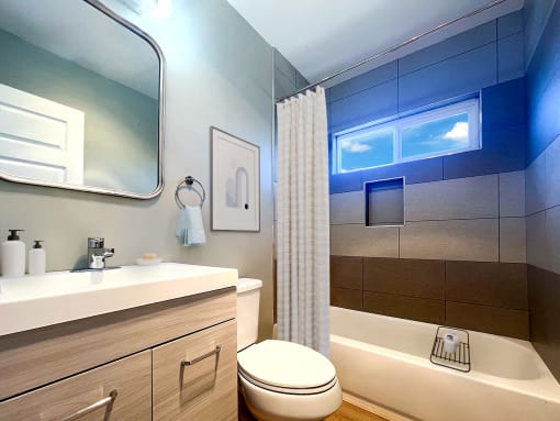 a bathroom with a toilet and a sink and a shower