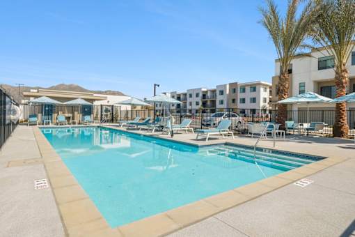 Resort style swimming pool with lounge chairs at Altitude Apartments, Moreno Valley, CA