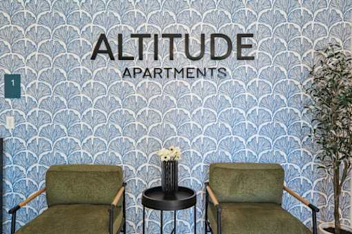 Stylish lobby seating area with decorative wallpaper at Altitude Apartments, Moreno Valley, 92553