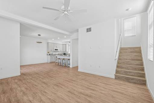 Open concept living area with modern kitchen at Altitude Apartments, Moreno Valley