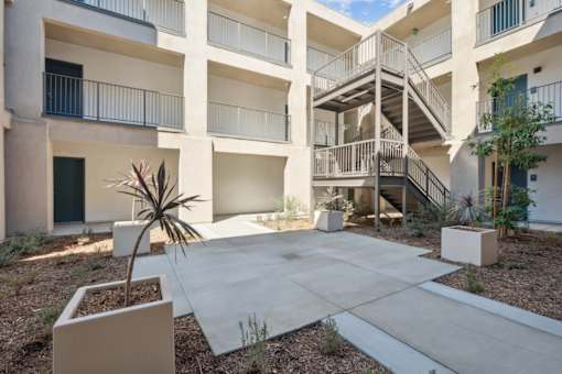 Outdoor courtyard with stairway and planter boxes at Altitude Apartments, California