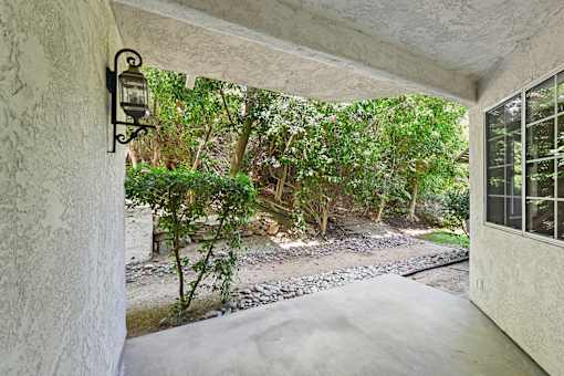 private patio at Cielo apartment home with gorgeous trees and cozy overhang