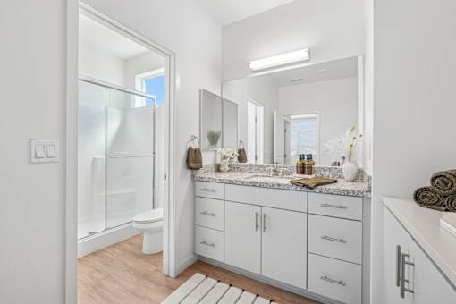 Spacious bathroom with dual vanity and walk-in shower at Altitude Apartments, Moreno Valley, California