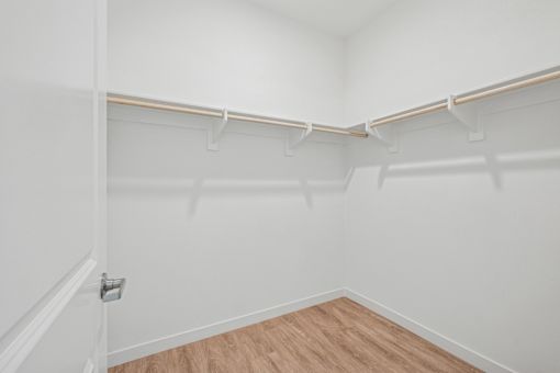 Spacious walk-in closet with dual hanging rods at Altitude Apartments, Moreno Valley