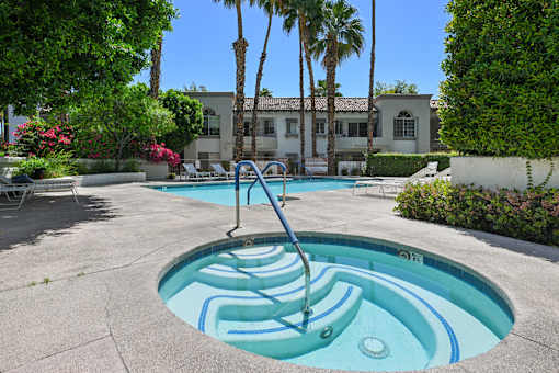 A pool with a slide in the middle of it.