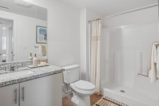 Bathroom with granite vanity and shower stall at Altitude Apartments, Moreno Valley, 92553