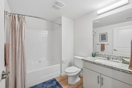 Contemporary bathroom with tub shower combo and vanity at Altitude Apartments, California, 92553