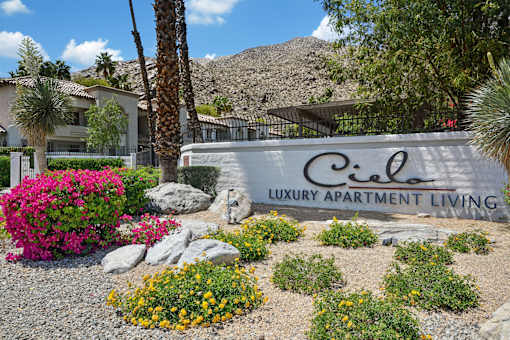 A sign that says "Ciel Luxury Apartment Living" in front of a building.